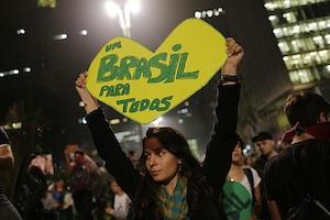 Picture: A woman holds up a sign that reads "One Brazil for all," in Sao Paulo, Brazil, where crowds gathered to celebrate the reversal of a fare hike on public transportation, courtesy Semilla Luz/Flickr.