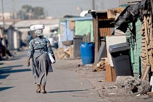 Picture: Woman walking in township courtesy WBUR Boston
