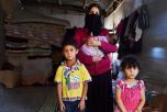 Picture: New arrivals in Lebanon last year. Refugee Khatar with three of her six children in a cowshed on a farm in the Bekaa valley (CAFOD Photo Library/flickr)