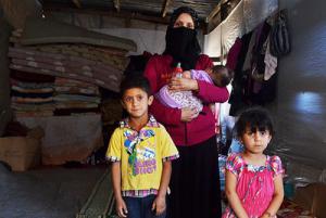 Picture: New arrivals in Lebanon last year. Refugee Khatar with three of her six children in a cowshed on a farm in the Bekaa valley (CAFOD Photo Library/flickr)