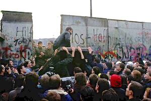 Picture: East and West Berliners tear down a portion of the Berlin Wall courtesy NPR.